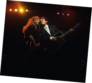 Bruce Springsteen and Patti Scialfa singing on stage